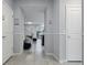 Clean and bright hallway with white trim, tile flooring, and views to the outdoor pool area at 3806 Lana Ave, Davenport, FL 33897