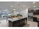 Spacious kitchen featuring a large island, stainless steel appliances, and a view of the backyard pool at 3806 Lana Ave, Davenport, FL 33897