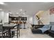Spacious open-concept living area with a modern kitchen, dining table, and comfortable sofa at 3806 Lana Ave, Davenport, FL 33897