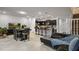 Open-concept living space with a kitchen, dining table, comfortable seating, and stairway to upper level at 3806 Lana Ave, Davenport, FL 33897