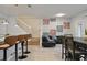 Living area boasts seating, adjacent dining and kitchen area with a staircase leading to the second floor at 3806 Lana Ave, Davenport, FL 33897