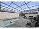 Relaxing pool area with a screen, patio furniture and pavers at 3806 Lana Ave, Davenport, FL 33897