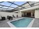 Relaxing pool area with a screen, patio furniture and pavers at 3806 Lana Ave, Davenport, FL 33897