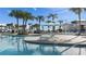 Resort style pool with lounge chairs and umbrellas surrounded by palm trees at 3806 Lana Ave, Davenport, FL 33897