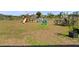 Spacious backyard featuring a swing set, outdoor seating, and ample room for recreational activities at 4743 Sw 114Th Pl, Ocala, FL 34476