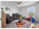 Comfortable bedroom with a crib, recliner, and play area at 4743 Sw 114Th Pl, Ocala, FL 34476