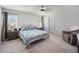 Serene bedroom with soft carpet, a ceiling fan, and natural light from the windows at 4743 Sw 114Th Pl, Ocala, FL 34476