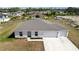 New construction highlighting the roof, windows, and landscaping, plus an attached two-car garage at 4743 Sw 114Th Pl, Ocala, FL 34476