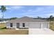 New construction showing the front of the home with large driveway, manicured yard, and two car garage at 4743 Sw 114Th Pl, Ocala, FL 34476