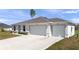 Charming single-story home featuring a spacious driveway and a three-car garage at 4743 Sw 114Th Pl, Ocala, FL 34476