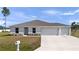 Inviting single-story home with a well-maintained lawn and a three-car garage at 4743 Sw 114Th Pl, Ocala, FL 34476