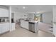 Bright kitchen with stainless steel appliances, an island, and an open layout connecting to the living area at 4743 Sw 114Th Pl, Ocala, FL 34476