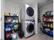 Laundry room with stacked washer and dryer, and shelving for storage at 4743 Sw 114Th Pl, Ocala, FL 34476