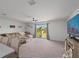 Bright living room featuring a comfortable sofa, ceiling fan, and sliding glass doors at 4743 Sw 114Th Pl, Ocala, FL 34476