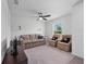 Cozy living room with a comfortable sofa, ceiling fan, and a window at 4743 Sw 114Th Pl, Ocala, FL 34476