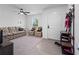Inviting living room with a sofa, ceiling fan, and practical shoe storage at 4743 Sw 114Th Pl, Ocala, FL 34476
