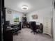 Home office featuring dual workstations, carpet flooring, and natural light at 4743 Sw 114Th Pl, Ocala, FL 34476