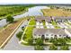 An aerial view of a townhome community bordering a tranquil lake and lush green spaces at 4801 Apple Blossom Ln, St Cloud, FL 34771