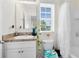 Bright bathroom features a single sink vanity and decorated toilet with shower and tub in background at 4801 Apple Blossom Ln, St Cloud, FL 34771