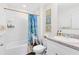 Clean bathroom features a single sink vanity with shower/tub combo with themed accessories at 4801 Apple Blossom Ln, St Cloud, FL 34771