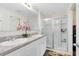 Bright bathroom features double sink vanity and glass enclosed shower with neutral paint at 4801 Apple Blossom Ln, St Cloud, FL 34771