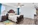 Bedroom features wood floors, with dark wood furniture, ceiling fan, and bright natural light at 4801 Apple Blossom Ln, St Cloud, FL 34771