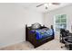 Bedroom with bed, blue blanket, and a window overlooking the backyard at 4801 Apple Blossom Ln, St Cloud, FL 34771