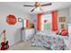 Fun bedroom features bright colored accents, neutral carpet, ceiling fan, and natural light at 4801 Apple Blossom Ln, St Cloud, FL 34771
