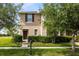 A two-story home with a manicured front yard, complete with a mailbox and neatly trimmed bushes at 4801 Apple Blossom Ln, St Cloud, FL 34771
