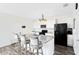 Kitchen featuring granite countertops, white cabinets, stainless appliances and island seating at 4801 Apple Blossom Ln, St Cloud, FL 34771