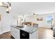Kitchen island with granite countertops, stainless steel sink and hardwood floors at 4801 Apple Blossom Ln, St Cloud, FL 34771