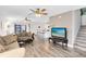 Bright living room with wood-look floors leading to a kitchen and screened patio at 4801 Apple Blossom Ln, St Cloud, FL 34771