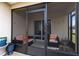 Screened patio features comfortable seating and sliding glass door to the interior of the home at 4801 Apple Blossom Ln, St Cloud, FL 34771
