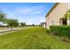 Well-manicured lawn surrounds a two-story home, complemented by verdant bushes and trees at 4801 Apple Blossom Ln, St Cloud, FL 34771
