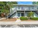 Inviting condo building featuring dual exterior stairs and neatly landscaped grounds, presenting a charming curb appeal at 4820 S Conway Rd # 131, Orlando, FL 32812
