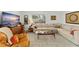 Well-lit living room with a large window, comfortable seating, and decorative art at 4820 S Conway Rd # 131, Orlando, FL 32812