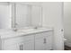 Bathroom with dual sinks, white cabinets, and granite countertops at 5227 Ligonberry St, Lakeland, FL 33811