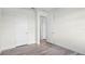 This bedroom features multiple doors, hardwood floors, and crisp white walls at 5227 Ligonberry St, Lakeland, FL 33811