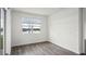 Cozy bedroom with wood-look flooring, window overlooking the lake, and view of exterior at 5227 Ligonberry St, Lakeland, FL 33811