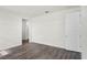 Light-filled bedroom featuring wood-look floors and an ensuite bathroom at 5227 Ligonberry St, Lakeland, FL 33811