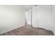 This bedroom features multiple doors, hardwood floors, and crisp white walls at 5227 Ligonberry St, Lakeland, FL 33811