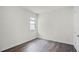 This bedroom features hardwood floors, a window, and crisp white walls at 5227 Ligonberry St, Lakeland, FL 33811
