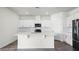Modern kitchen with white cabinets, stainless steel appliances, subway tile backsplash, and a center island at 5227 Ligonberry St, Lakeland, FL 33811