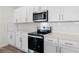 Close up of modern kitchen showcasing stainless steel appliances, white cabinets, and subway tile backsplash at 5227 Ligonberry St, Lakeland, FL 33811