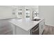 Kitchen island with a stainless steel sink and view of the Living Room with large window overlooking the lake at 5227 Ligonberry St, Lakeland, FL 33811