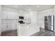 Modern kitchen with white cabinets, stainless steel appliances, subway tile backsplash, and a center island at 5227 Ligonberry St, Lakeland, FL 33811