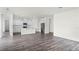 Open floor plan showcasing living room blending into modern white kitchen with stainless steel appliances at 5227 Ligonberry St, Lakeland, FL 33811