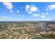 An aerial view of a neighborhood with multiple ponds, trees, and grasslands surrounding the homes at 5270 Wildwood Way, Davenport, FL 33837