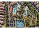 Aerial view showcases a resort-style community pool, tennis courts, and lush greenery at 5270 Wildwood Way, Davenport, FL 33837