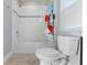 Bathroom featuring decorative shower curtain and white tiled walls at 5270 Wildwood Way, Davenport, FL 33837